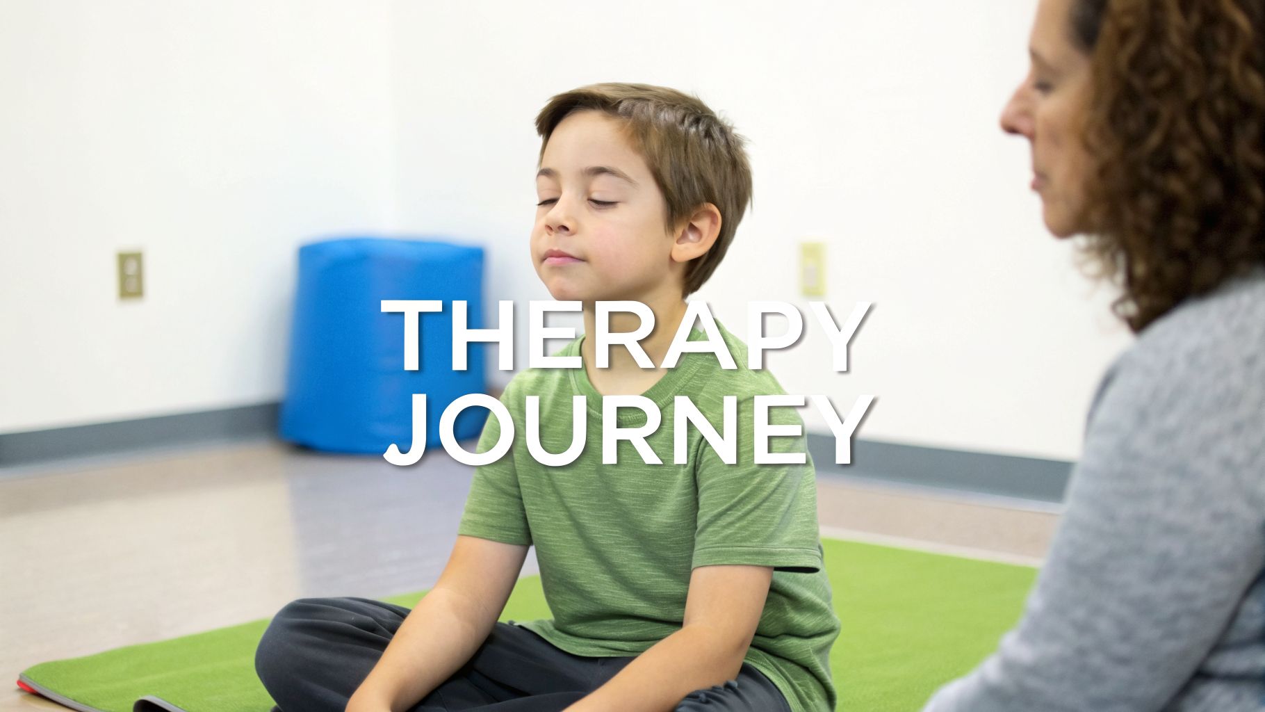 A young boy with closed eyes sits on a green mat, practicing mindfulness with an adult nearby during a therapy journey.
